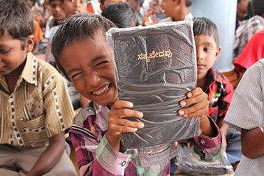 This young boy, who lives in an orphanage run by St Thomas Academy Trust, was happy to get a Bible from the Bible Society of India.