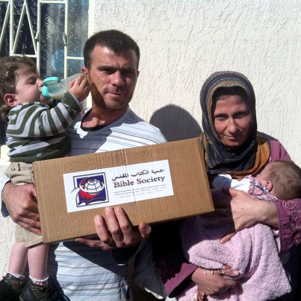 Syrian refugees receiving relief packages and Scriptures from the Bible Society of Lebanon