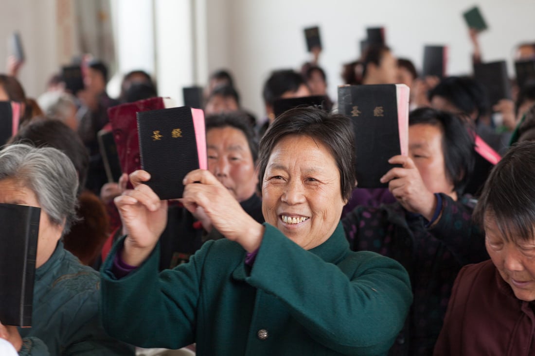 A congregation in China display their Bibles